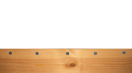 Top view light wood texture surface with natural pattern and metal nail heads or hats. Wooden pine board isolated on white. Spruce table with knots. Rustic craft. Workbench. Box edge.