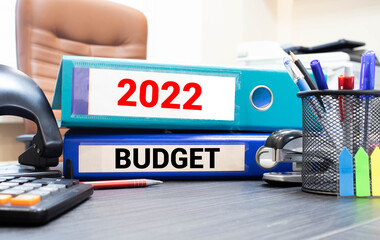 budget 2022, text on white paper in a white frame on a gray background near the office