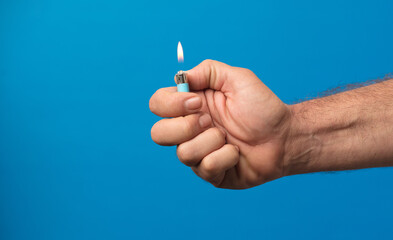 man hand with lighter with fire flame