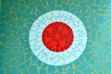 White Circular Mosaic Pattern with Red Centre on  Green Ceramic Wall 