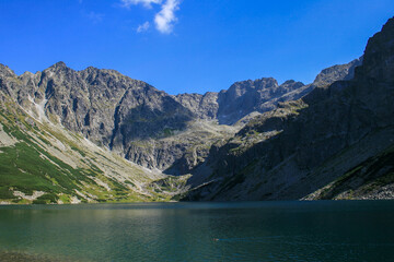 Naklejka na ściany i meble A small lake among the mountains