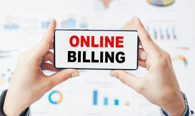 Smartphone with the text ONLINE BILLING in a hands. Business concept.
