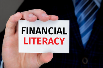 Broker. Businessman in suit with tie showing or holding business card with text FINANCIAL LITERACY