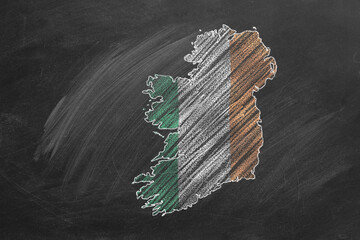 Country map and flag of Ireland drawing with chalk on a blackboard. One of a large series of maps and flags of different countries. Education, travel, study abroad concept.
