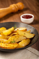 Roasted potatoes with rosemary on the plate.