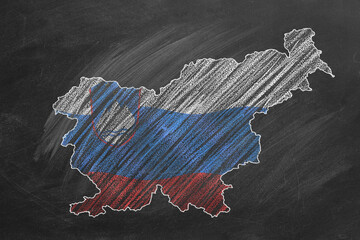 Country map and flag of Slovenia drawing with chalk on a blackboard. One of a large series of maps and flags of different countries. Education, travel, study abroad concept.
