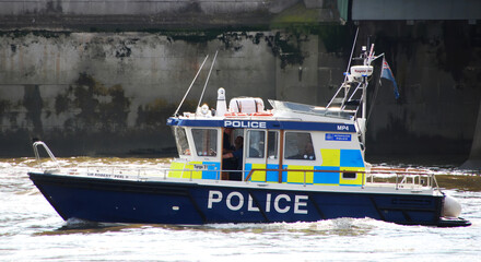 English patrol Police boat patrolling on the River Thames. London - Powered by Adobe