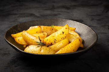 Roasted potatoes with rosemary on the plate.