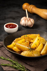 Roasted potatoes with rosemary on the plate.