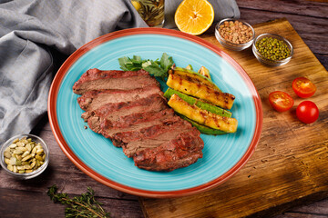 Sliced sirloin Steak Roast Beef on a dark wooden table background.
