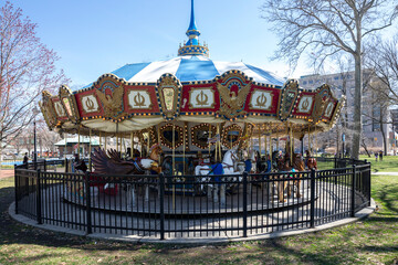 An empty, colorful, old fashion carousel for kids in a park in Philadelphia