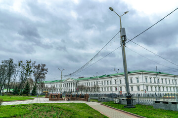 Poltava, Ukraine - April 14, 2021: ancient white building with columns, the office of the city council in Poltava, Ukraine. Famous 19th century building in Hull Park. Historical and tourist attraction