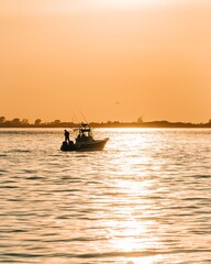 Boat at sunset in the Great South Bay, seen from Kismet, Fire Island, New York