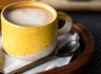 Yellow cup of cappuccino