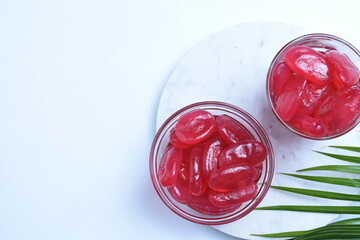 Manisan Kolang Kaling (Preserved Sugar Palm Fruit) with Red Color. Served in a Glass and mini glass bowl,isolated white background