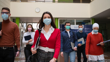 students group at university walking and wearing face mask