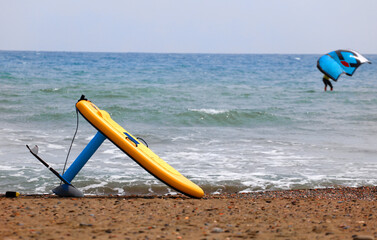 hydrofoil board on the sand, deep sea with windfoil kite