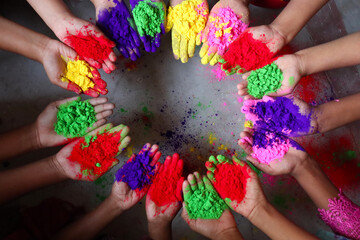 multiple colored powder on hands