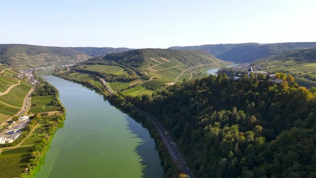 Rising aerial drone shot of the Moselle River bend in Bremm, Germany.