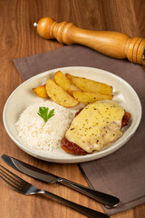 Parmigiana steak with rice and roasted potatoes. Typical Brazilian dish.