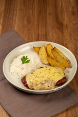 Parmigiana steak with rice and roasted potatoes. Typical Brazilian dish.