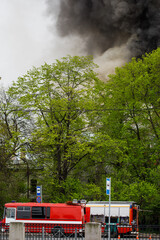 black smoke trail of burning house