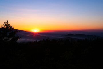 Sunset over bed of clouds