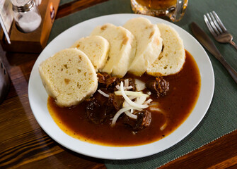 Appetizing goulash with potato dumplings. Traditional czech dish. High quality photo