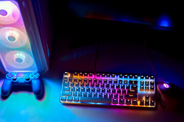 Joystick, keyboard and mouse with RGB light. Gamer's workspace, neon light. Desktop computer with...
