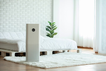 Air purifier in cozy white bedroom for filter and cleaning removing dust PM2.5 HEPA in home,for...