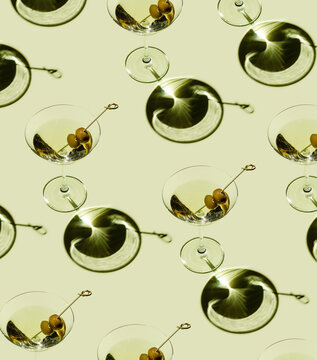 Classic Martini Cocktail with green olives on green background Pattern