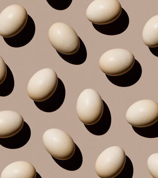 Chicken eggs on beige background Pattern