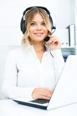 Friendly girl technical support person or call center manager in the office.