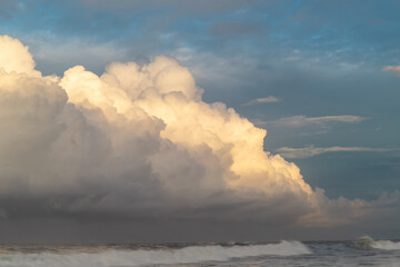 Fluffy white clouds on cloudy blue sky.