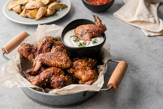 Chicken wings with dips and potatoes