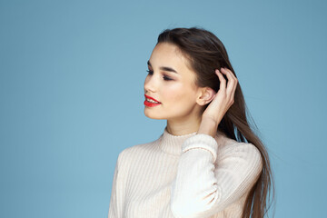 Pretty woman red lips white jacket attractive look close-up blue background