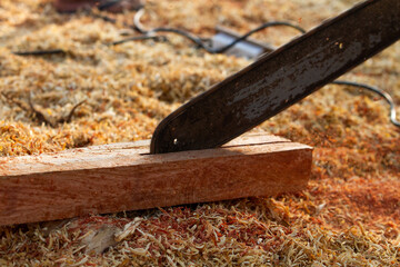 Chainsaw Close-up of woodcutter sawing chain saw in motion,