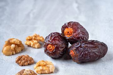 Medjool Dates and walnuts on marble floor It is a highly useful food. It is popular to eat in the Islamic month of Ramadan.
