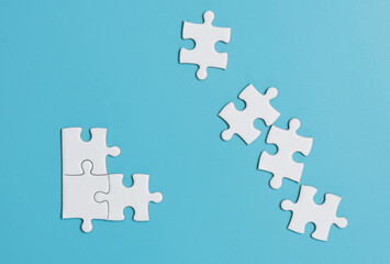 White jigsaw puzzle on blue background.