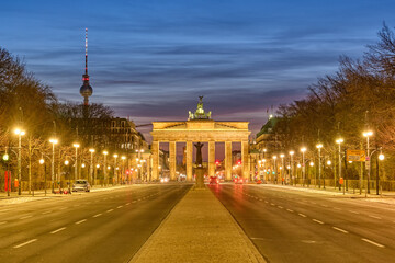 The famous Brandenburg Gate in Berlin with the Television Tower at dawn
