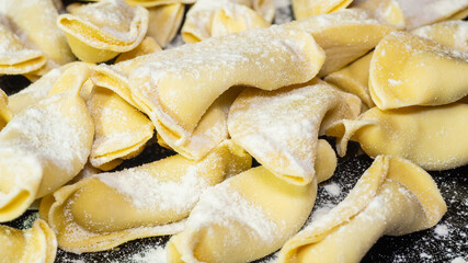 A kind of ravioli, casoncelli, home made traditional food of the Bergamo area, Italy. Delicious Italian food. Black background