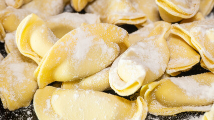 A kind of ravioli, casoncelli, home made traditional food of the Bergamo area, Italy. Delicious Italian food. Black background