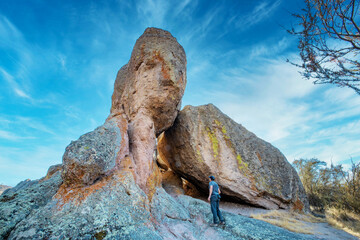San Benito County and Monterey County, California, USA - October 10, 2020, a tourist near a large rock in Pinnacles National Park. Concept, active recreation in nature, tourism.