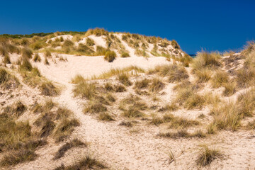 Sand dunes on a hiking trail near Cala Mesquida beach on Mallorca island in Mediterranean Sea