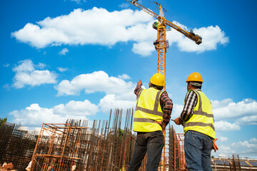 Construction team engineers speak to architects at construction sites or construction sites for...