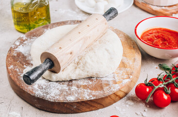 The ingredients for homemade Margherita pizza on stone background.