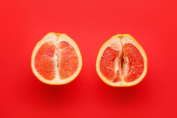 Cut grapefruit on color background. Erotic concept