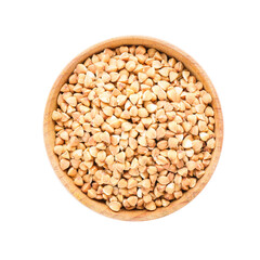 Bowl with dry buckwheat on white background