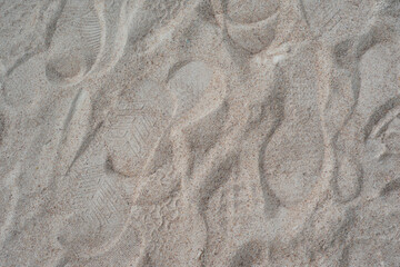 Fototapeta na wymiar Footprints on the soft sandy beach. 