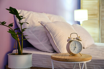 Alarm clock on table in bedroom